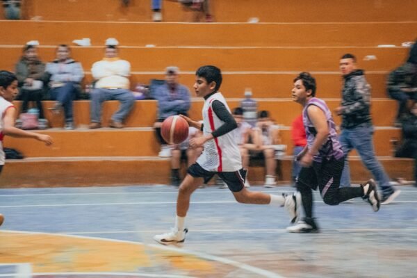 A group of young men playing a game of basketball