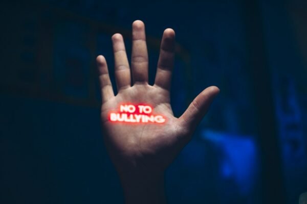 a hand with the word no to bullying written on it
